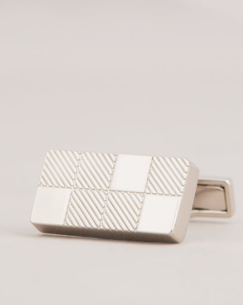 CHECKYU-Cufflinks-For the man who appreciates the finer things in life, CHECKYU are a must-have accessory. We've taken these cufflinks to the next level with our exclusive house check texture and sleek modern design. What more could he ask for? Cufflinks House check texture Metallic plating Ted Baker branded Comes in Ted Baker branded packaging- Ted Baker Romania